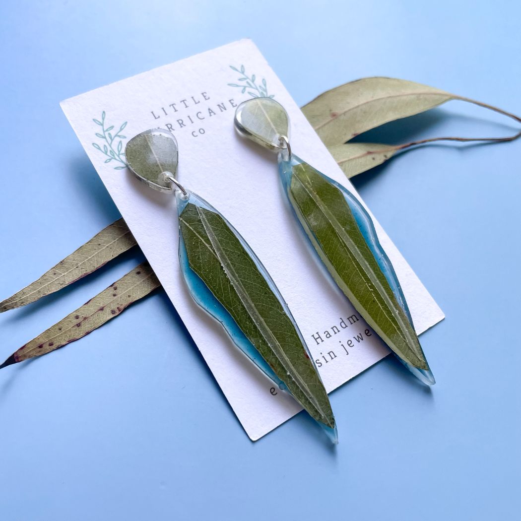 Eucalyptus leaf dangle earrings on blue